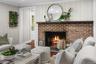 A classic brick hearth adds warmth and timeless character to this newly renovated gathering space.