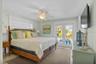 Main floor primary bedroom with balcony
