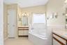 The Primary en suite boasts DUAL CLOSETS, including a WALK-IN, along with a private en-suite bath featuring dual vanities, GARDEN TUB and step-in show