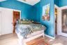 Bedroom featuring wood finished floors and baseboards
