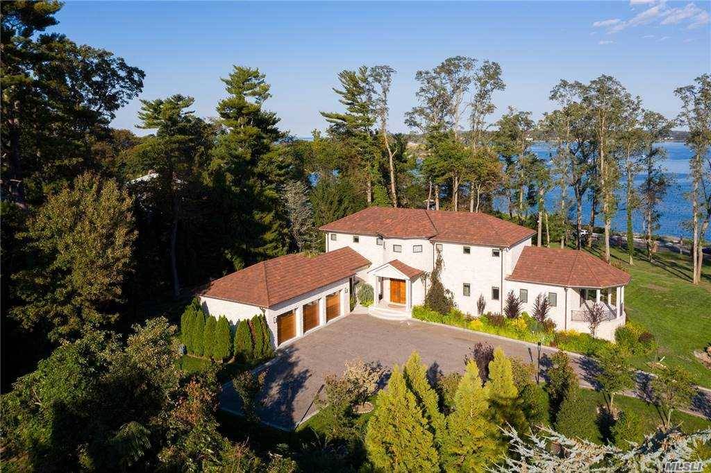 Spectacular waterfront estate set on 3 manicured acres complete with specimen plantings and a perennial garden with seasonal blooms.