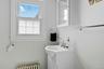 Full bathroom with shower featuring vanity, plenty of natural light, and radiator