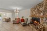 Cozy fireplace gathering area centered around a charming wood-burning fireplace, creating a warm and inviting space to relax, unwind, and enjoy time w