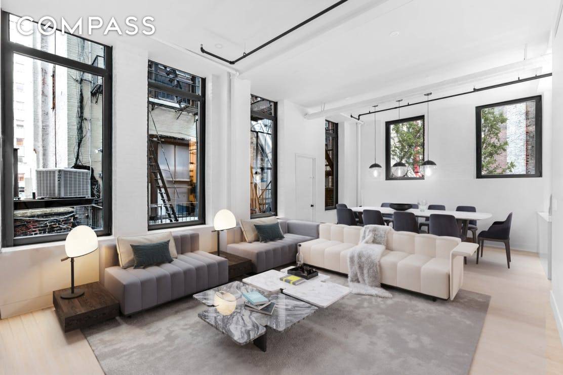 FLATIRON LOFT WITH ENDLESS POSSIBILITIES Seize the potential of this prewar loft featuring ten oversized windows and 12 ceilings with space to spare and volume galore.