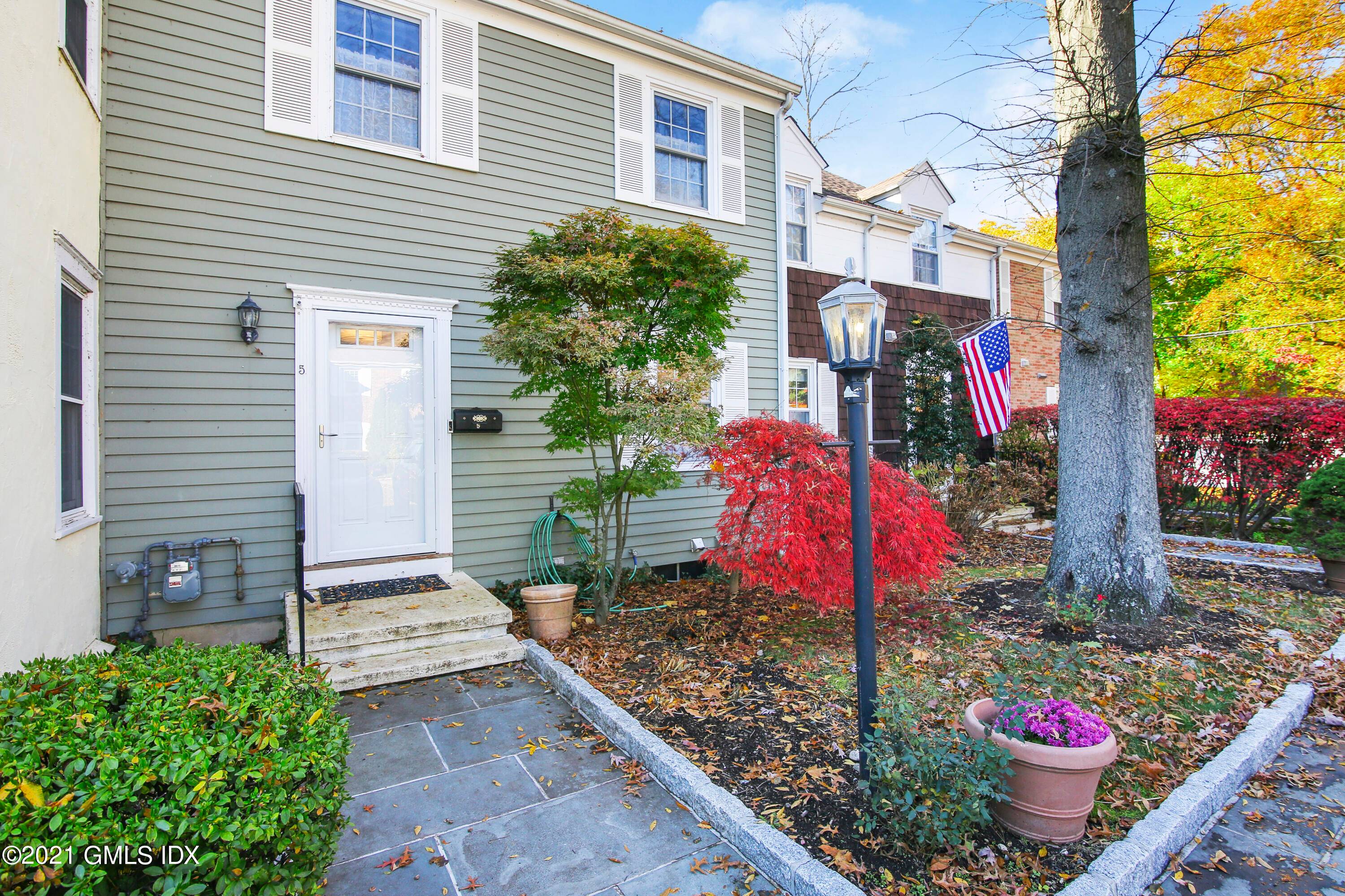 Turnkey three bedroom Townhome showcases a sunny interior with stone patio nestled in private, peaceful complex in a convenient Cos Cob location.