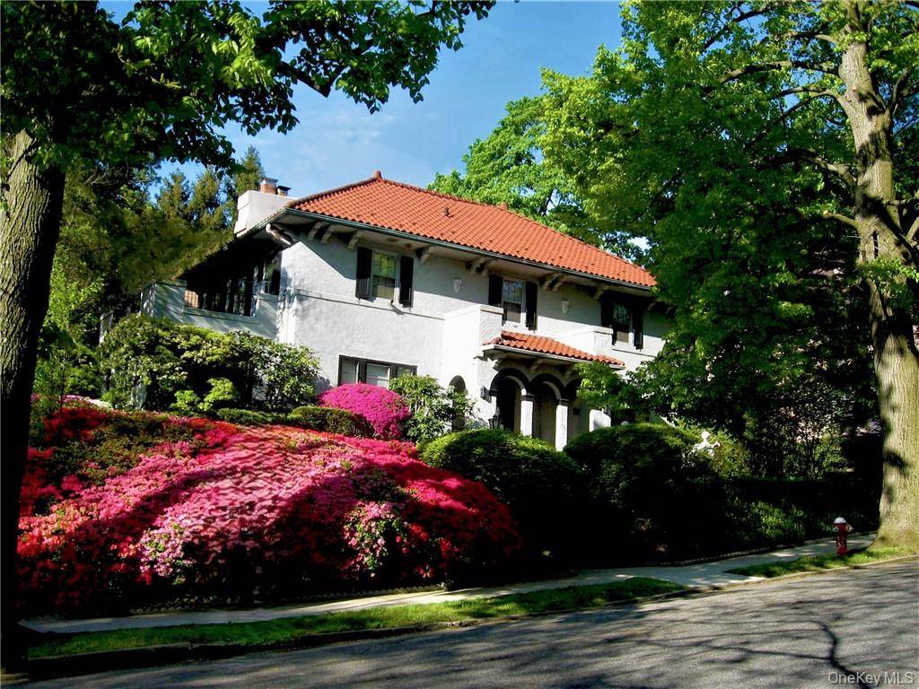 This stately Mediterranean villa near Bronxville is set high on a private, lushly landscaped large corner property.
