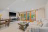 Living room with light tile patterned floors and recessed lighting