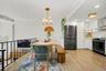 The dining area opens seamlessly to a beautifully appointed kitchen while overlooking the dramatic step-down living room, creating an open, airy layou