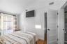 Bedroom with hardwood / wood-style flooring and lofted ceiling