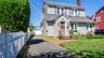 Traditional two-story colonial with gray siding and coordinating roof