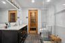Full bath with vanity, tile walls, a sauna / steam room, a stall shower, and recessed lighting
