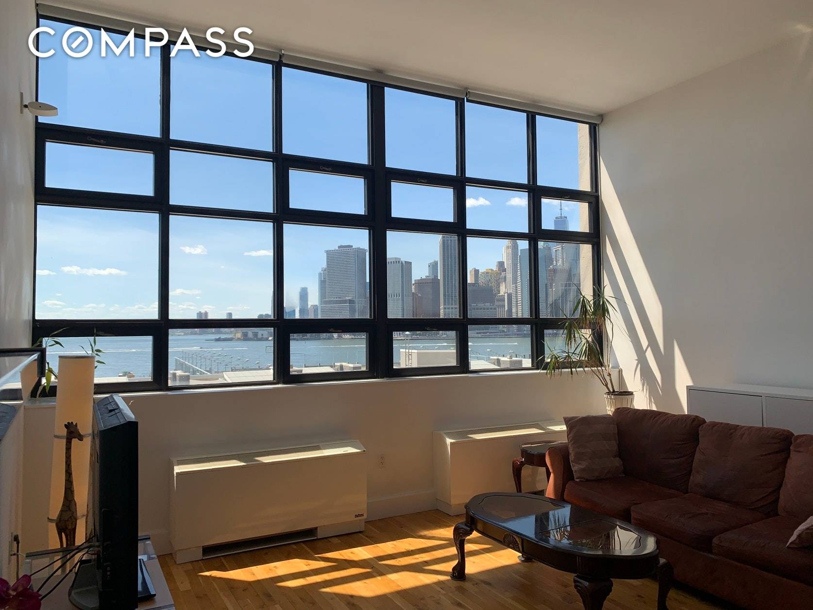 Spectacular Statue of Liberty and New York harbor views from a 901sf loft with huge windows and high ceilings.