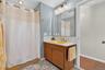 Bathroom with curtained shower and vanity