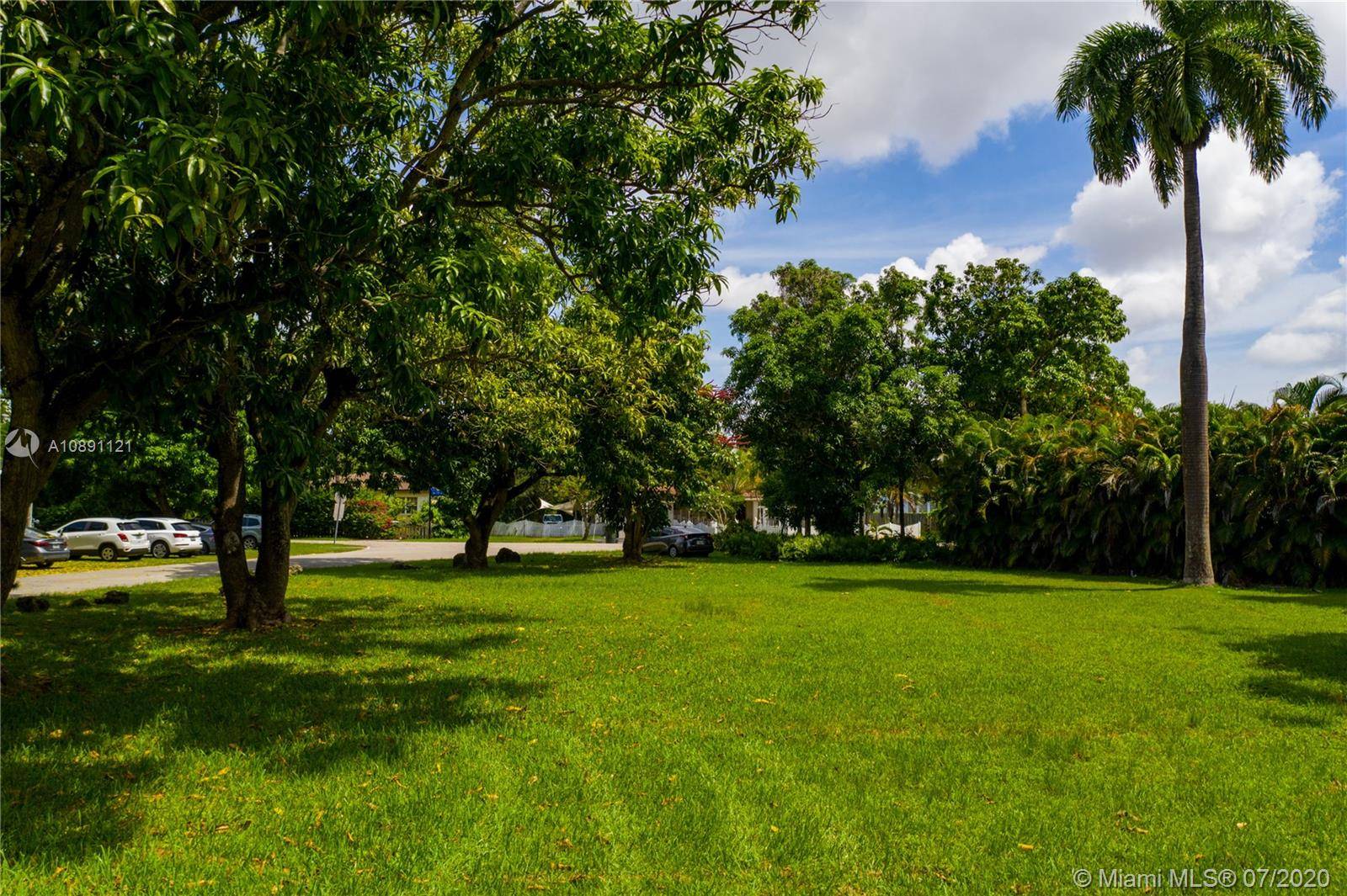 Park like setting residential lot with mango and picture perfect Royal Poinciana trees.
