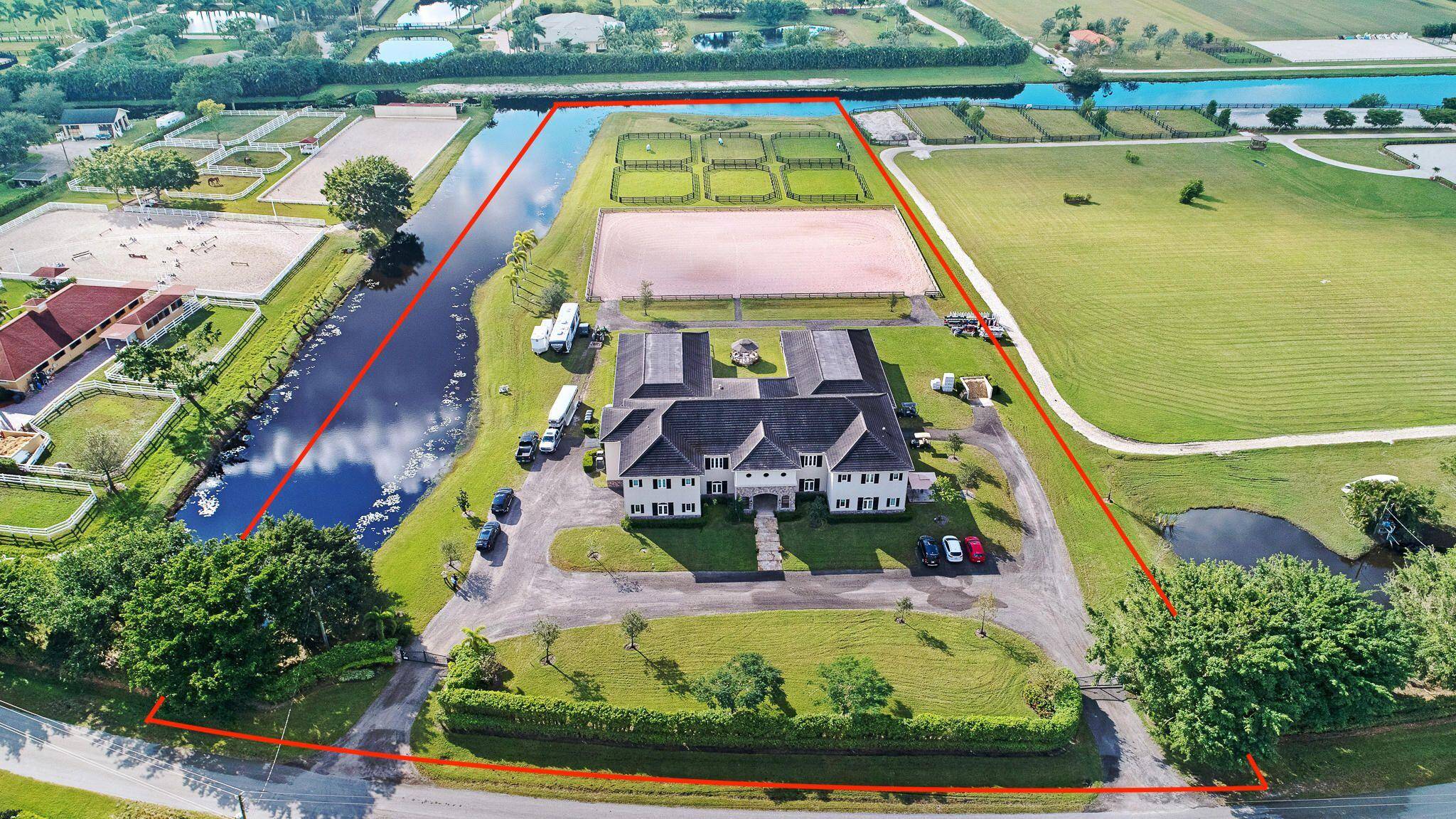 Exceptional 5. 5 acre equestrian facility consisting of two 12 stall wings, each with their own feed and tack rooms, equaling a Total of 24 stalls with a 2 bedroom ...