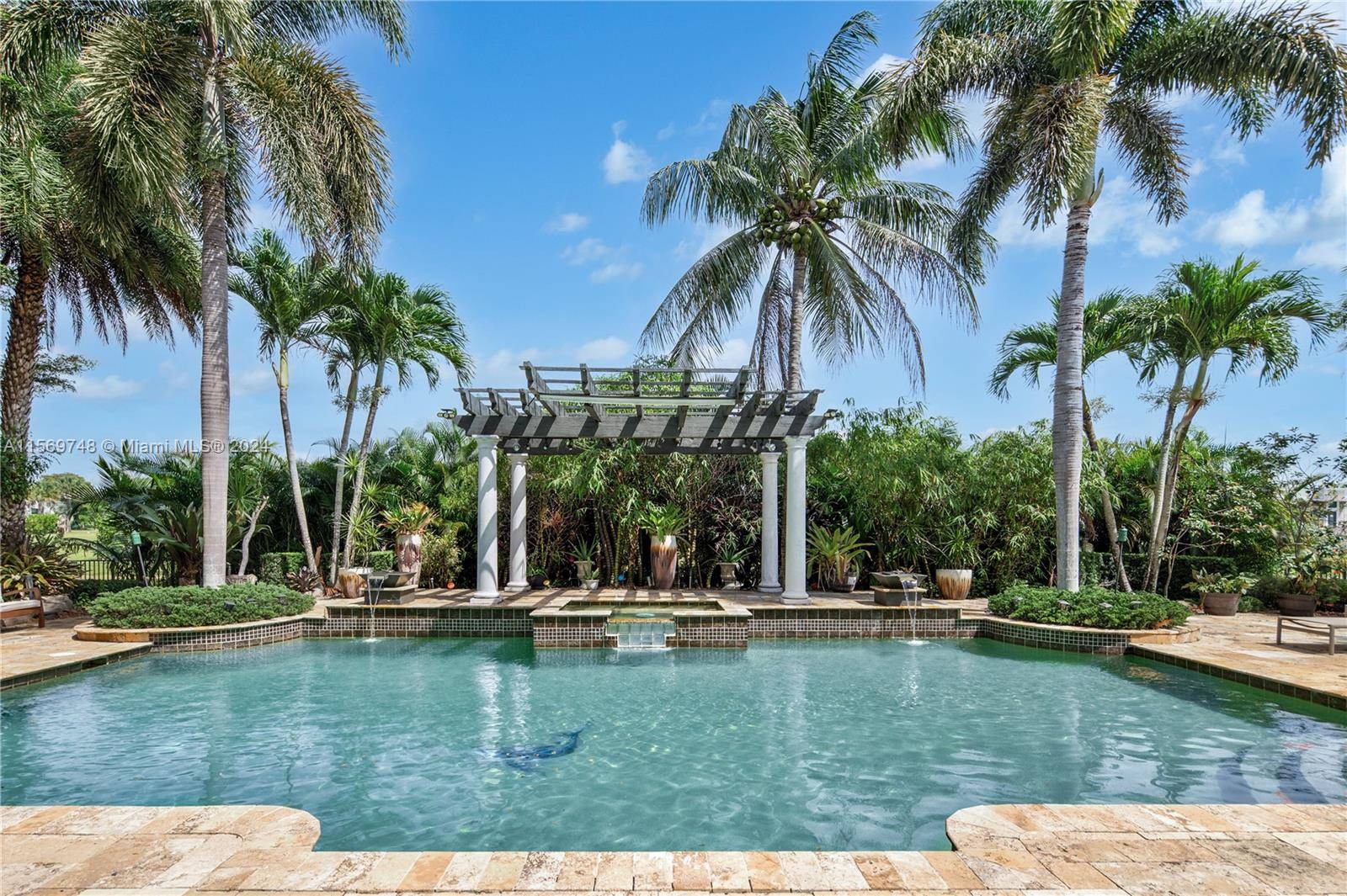 Located within Stonebrook's gated community, this majestic estate rests along the tranquil shores of a serene lake.