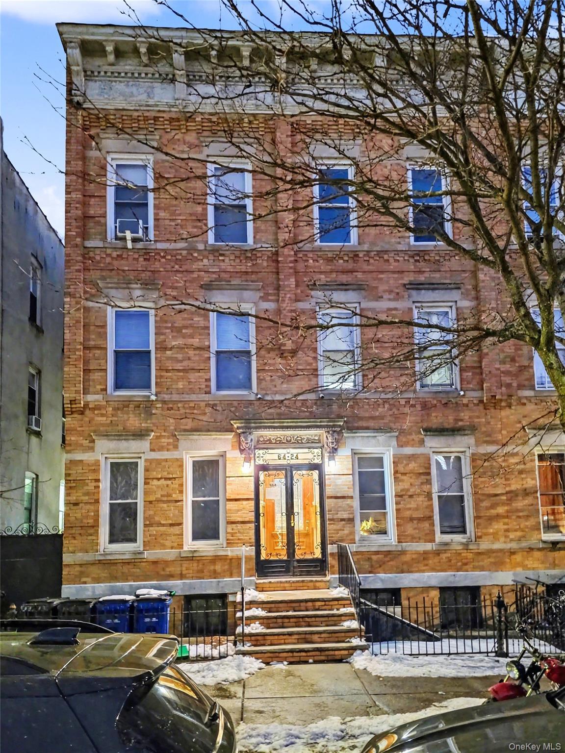 View of front facade featuring a fenced front yard and brick siding