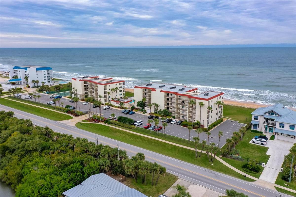 A wider angle highlights the community’s prime beachfront location, surrounded by natural dunes and scenic coastline.