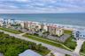 A wider angle highlights the community’s prime beachfront location, surrounded by natural dunes and scenic coastline.