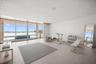 Virtually staged flex space on first floor is under air and overlooks the pool, spa and private beach