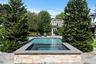 View of swimming pool featuring a patio and a pool with connected hot tub