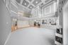Unfurnished living room featuring a high ceiling, recessed lighting, coffered ceiling, beamed ceiling, and light carpet