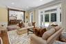 Living area with a wainscoted wall, dark wood-type flooring, ornamental molding, french doors, and recessed lighting