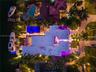 Direct overhead aerial showing full rooftop footprint, illuminated pool and spa, private dock with two vessels, paver motor court, covered entry corri