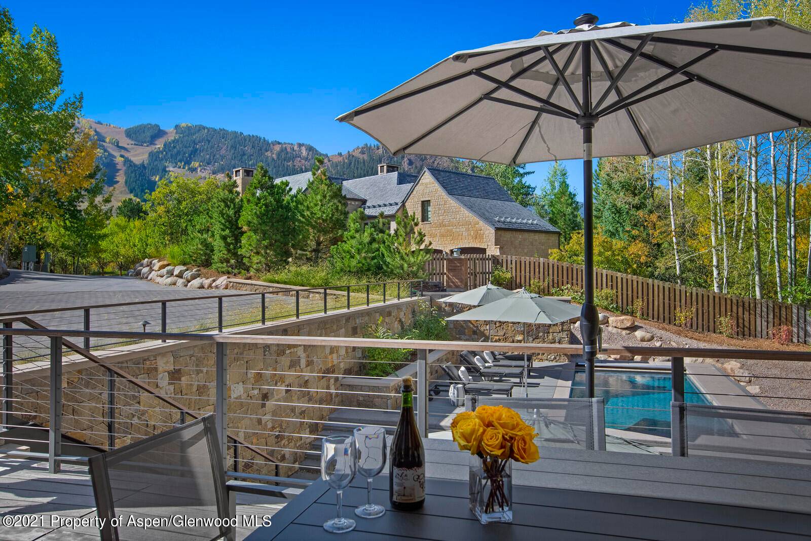 THIS ELEGANT AND BEAUTIFULLY APPOINTED FOUR BEDROOM HOME ENJOYS VIEWS OF ASPEN MOUNTAIN FROM THE FRONT AND HUNTER CREEK RUNNING BEHIND.