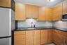 Kitchen featuring appliances with stainless steel finishes, a sink, tasteful backsplash, and dark stone counters
