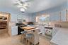 The kitchen is located right off of the formal dining room and has an entry into the informal areas. The doorway in the rear of the picture leads int