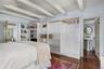 Light-filled guest bedroom with custom built-ins and en suite half bath