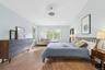 Bedroom featuring light wood finished floors, lofted ceiling, and recessed lighting