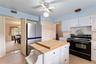 Kitchen with view into formal dining room. There are two pantry closets