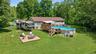 Expansive backyard featuring a large above-ground pool with a surrounding wood deck