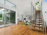Stairs featuring wood finished floors, recessed lighting, and a towering ceiling