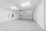 Spacious garage with golf cart parking and epoxy flooring
