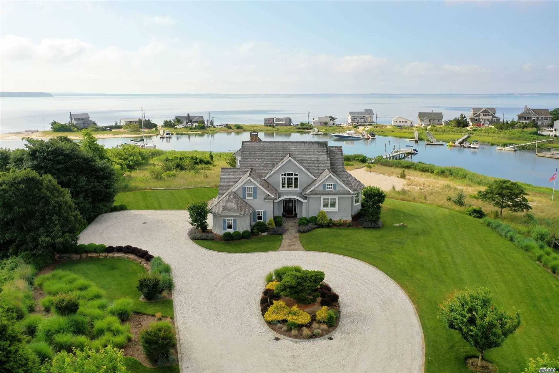 Let the breeze roll in from this Mattituck waterfront, bay view oasis.