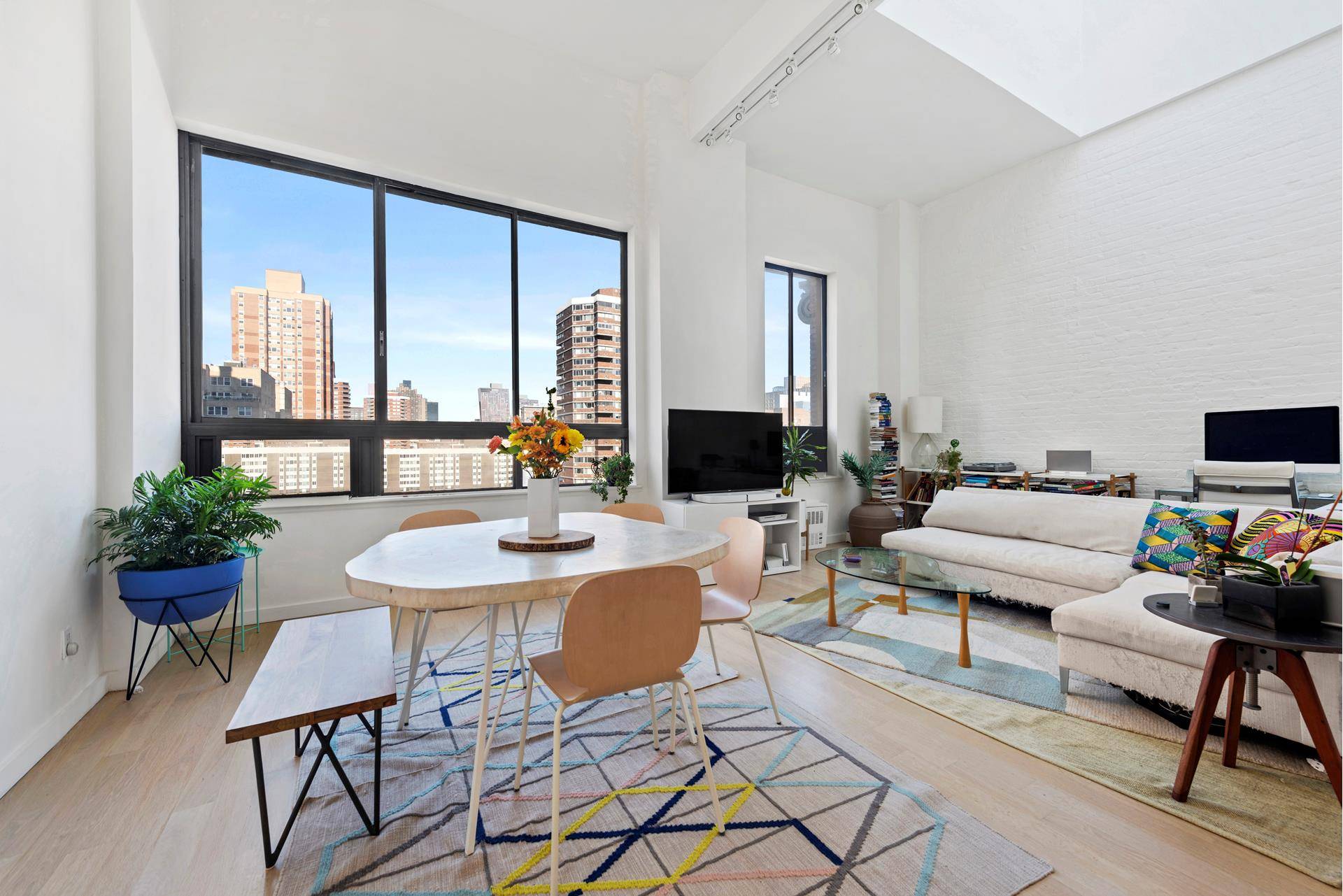Sun drenched one bedroom loft with 20 foot ceilings and mezzanine home office.