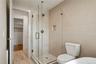 Full bathroom with wood finished floors, a stall shower, and a spacious closet