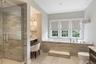 Full bathroom with vanity, a bath, and a stall shower