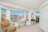 Master bedroom seating area and balcony with water view