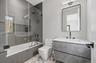 Bathroom featuring tiled shower / bath and vanity