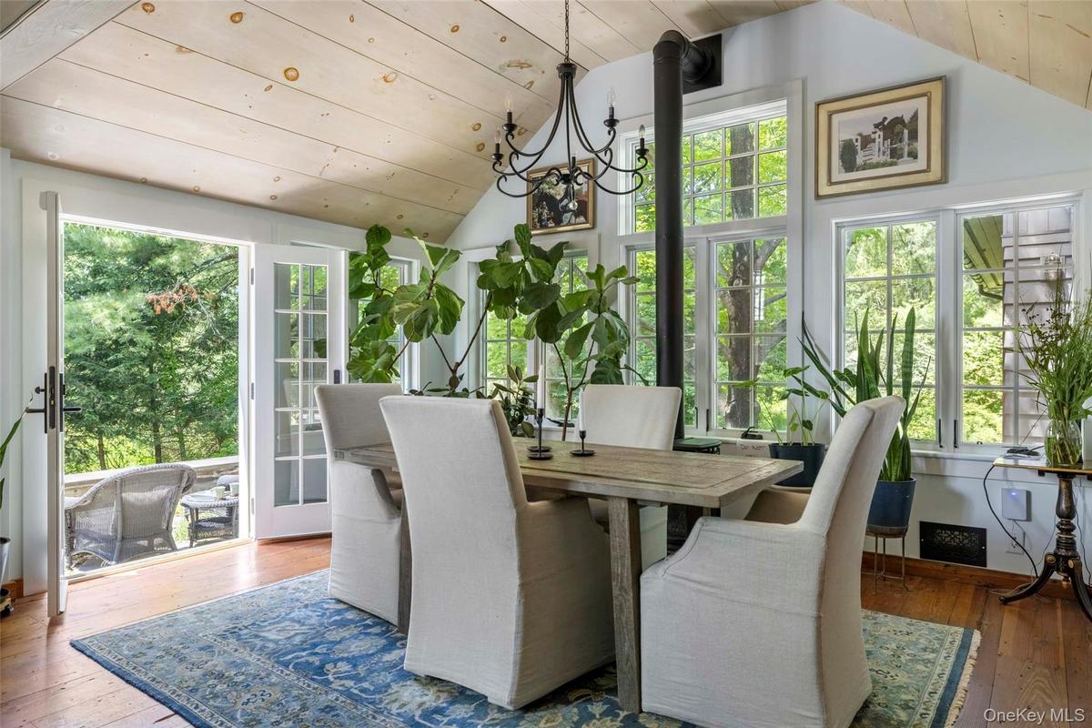 French doors open to the stone terrace with wood-fired pizza oven