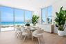 Dining area is surrounded by 11 foot impact glass windows and sliders