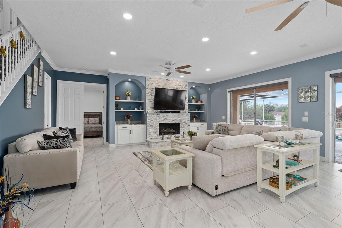 Family Room with custom stone fireplace, tile throughout the main floor, this whole home has been completely remodeled to perfection.