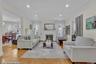 Spacious living area featuring light wood-finish flooring, recessed lighting, and crown molding