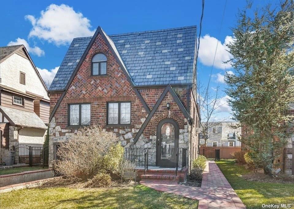 Beautiful Village Tudor with Living Room, open and recently renovated Kitchen and Dining Room leading to Den.