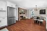 The heart of the home — this open kitchen and dining area blend modern design with a touch of classic warmth, anchored by a second brick fireplace.