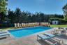 View of pool featuring a patio, an outdoor structure, and a lawn